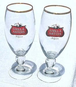 NUEVO STELLA ARTOIS Tallo Vasos de Cerveza Lote de 2 Borde Dorado - Imagen 1 de 4