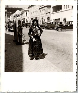 A COSTUMED WOMAN POSES BY SACOR GAS PUMP: VIANA DO CASTELO DISTRICT IN PORTUGAL - Picture 1 of 3