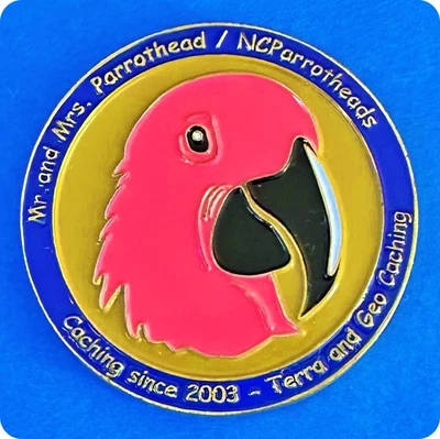 Geocoin NCParrotheads Pink Macaw Foothills Geocachers Ant. Gold Non-Trackable - Image 1 of 2