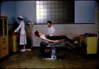 1950s Exam room Solemn doctor tells sexy patient she has cancer slide s674