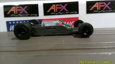 AFX RACING H.O. ESCALA MEGA G+ 1.7 CHASIS ESTRECHO NEGRO LLANTAS 5 RADIOS CÁMARA ROJA Foto 1 de 4