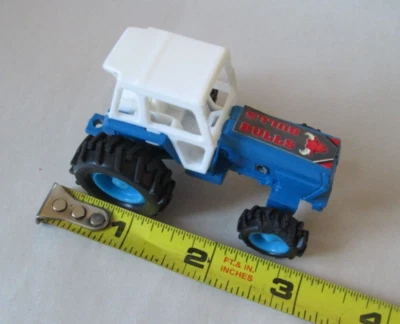 Diecast Blue Farm Tractor with Cab and Bulls Decal on Hood 1/64 - Image 1 of 4
