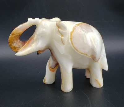 Hand Carved Onyx Elephant 4.5in tall Brown Rust & Green Colors - Image 1 of 4