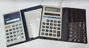 (2) Casio Solar Powered Calculators SL-300 & SL-300G With Covers Tested Works - Picture 1 of 7