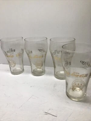 CONJUNTO DE 4 COPOS DE COCA COLA OLIMPÍADAS 1976 12 OZ, 5 IDIOMAS, LETRAS DOURADAS - Imagem 1 de 4