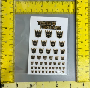 Adesivi Repro Decepticon Transformers Oro Nero Etichette Sigilli Simboli - Foto 1 di 1