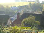 Photo 6x4 Newton St Cyres Half Moon Village Houses appear to steam in the c2006