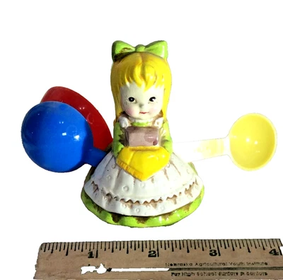VINTAGE PORCELAIN SMALL 3" GIRL WITH 4 PLASTIC MEASURING SPOONS JAPAN - Image 1 of 3