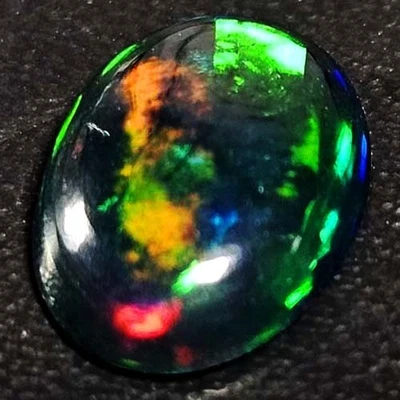 NATURAL AAA+BEAUTIFUL COLORPLAY OVAL CABOCHAN  ETHIOPIAN WELO BLACK OPAL 1.30CTS - Image 1 of 3