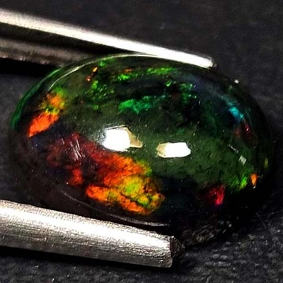 NATURAL AAA+AWESOME COLOR PLAY OVAL CABOCHAN  ETHIOPIAN WELO BLACK OPAL 1.35 CTS - Image 1 of 3