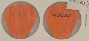 WEEZER - PÚA DE GUITARRA NARANJA CONCIERTO BRIAN BELL TOUR ANTIGUO VINTAGE - Imagen 1 de 1