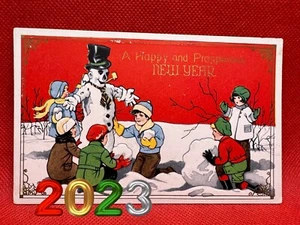 Cartolina antica "Buon/Prospero Anno Nuovo" | Pupazzo di neve e bambini - Foto 1 di 2