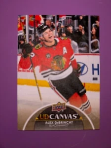 2021-22 Upper Deck Series 1 Canvas #C137 Alex DeBrincat Chicago Black Hawks - Picture 1 of 2