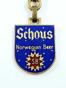 SCHLÜSSELANHÄNGER - Augis - BRAUEREI SCHOUS Norwegisches Bier METALL EMAILLIERT 60er Jahre - Bild 1 von 3