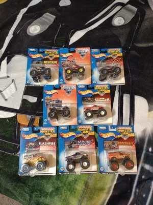 Lot 8 Hot Wheels Monster Jam 5-O, Wolverine, Gun Slinger & More 1:64 Scale  - Image 1 of 4