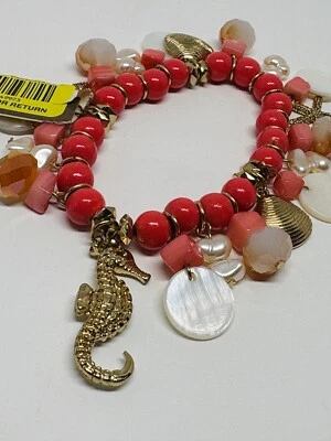 Brazalete con dije elástico estrella de mar tono dorado concha de caballito de mar cuentas tono coral playa Foto 1 de 4