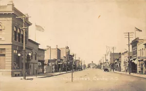 Cando ND Main Street Storefronts Old Cars RPPC Postcard - Picture 1 of 2