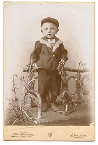Vintage cabinet card of young boy with toy horse pull toy, on rustic twig bench - Picture 1 of 2