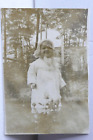 Antique Photo Of A Toddler Girl Standing In Front Of A Rosebush Wearing Coat Hat