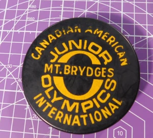 Vtg Canadian American Junior Olympics International Mt. Brydges Hockey Puck - Picture 1 of 3