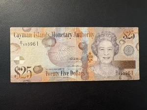 Billete de 25 dólares 2010 de las Islas Caimán Reina Isabel II QE2 - Imagen 1 de 3