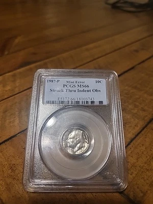 1987-p Roosevelt Dime Mint Error Struck Thru Indent Obv  PCGS MS66 Uncirculated - Image 1 of 4