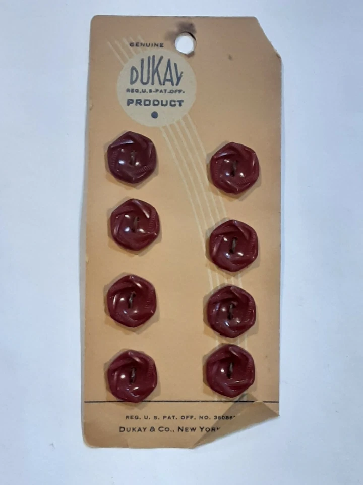 8 VINTAGE DUKAY BUTTONS ON CARD - Image 1 of 1