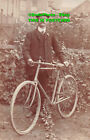 R432178 A man with a hat and a mustache is standing on a bicycle
