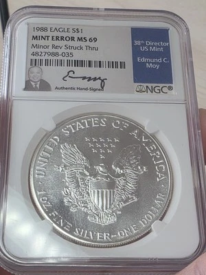  1988 American Silver Eagle Error Minor Struck Thru OBV NGC MS69 Ed Moy Signed  - Image 1 of 4