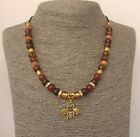 Handmade Necklace with brown and amber beads and a gold coloured Honeybee charm.