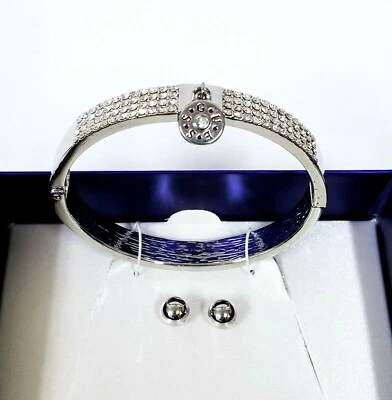 JUEGO CAJA GUESS TONO PLATA, CRISTALES, PULSERA CON DIJES, BRAZALETE, BRAZALETE + ARETES DE BOLA Foto 1 de 4