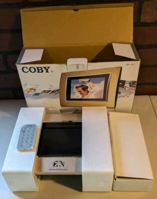 Coby 5.6” Digital Photo Frame W/MP3 Player In Original Box. DP-557 - Image 1 of 4