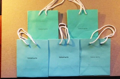 LOT OF 4 AUTHENTIC TIFFANY & CO. 6X5X3 BLUE PAPER BAGS. HANDLES INTACT. PREOWNED - Image 1 of 4