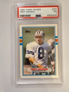 Tarjeta de novato de fútbol americano 1989 Topps Traded Troy Aikman RC #70T clasificación PSA casi nueva 7 - Imagen 1 de 1