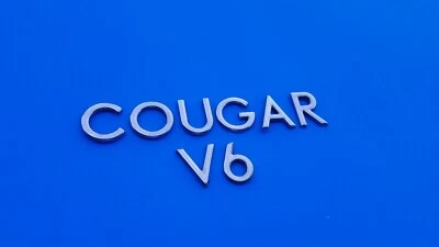 99 00 01 02 MERCURY COUGAR V6 TAPA TRASERA CROMO EMBLEMA LOGOTIPO INSIGNIA SIGNO USADO OEM A1 Foto 1 de 3