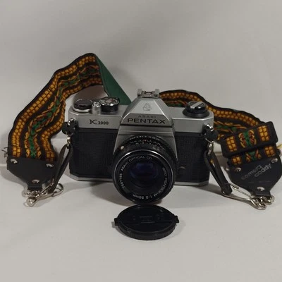 Cámara fotográfica Pentax Asahi K1000 35 mm SLR con lente de enfoque manual de montaje PK de 50 mm PROBADA Foto 1 de 4