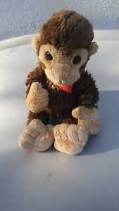 Plush Monkey with a hart symbol and  bend on the wrist. stuffed animal