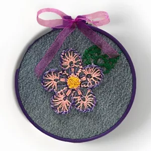 Embroidered Pink Flower On Recycled Denim With A Purple Embroidery Hoop Frame - Picture 1 of 2