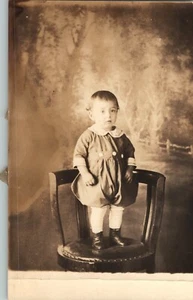 Unknown Toddler Standing on a Chair in Photo Studio RPPC Postcard - Picture 1 of 2