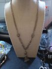 Womens gold toned chain neclace with tassel pendant with scratches