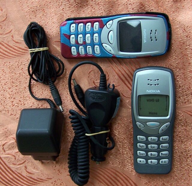 The legendary Nokia 3210, Nokia's very first mobile phone without an  external antenna. This one sports a more unusual, red housing instead of  the standard dark grey one. The original colored covers