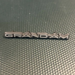 1985-91 Pontiac Grand Am Dash Dashboard Emblem Badge Logo Nameplate  - Picture 1 of 6