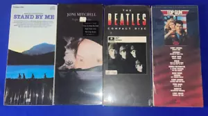 SET-(4) VERSIEGELTE CD in LONGBOX Top Gun/Stand By Me/Meet Beatles/Joni Mitchell Ride - Bild 1 von 4