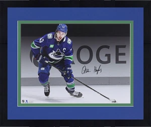 Framed Quinn Hughes Vancouver Canucks Autographed 16" x 20" Blue Spotlight Photo - Picture 1 of 1