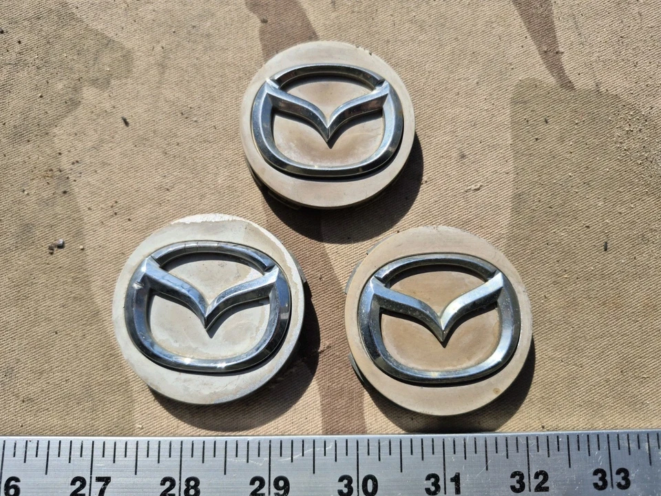 TAPAS CENTRALES DE RUEDA 082874 para MAZDA CX-3, CX-5, CX-9 MX-9 / OEM / USADO / LOTE DE 3 Foto 1 de 4