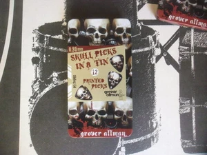 GROVER ALLMAN 12 skull picks in a tin- 12 mediators skull 0.80mm-NEUF - Imagen 1 de 3