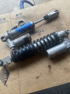 08 09 10 11 12 13 Yamaha Rhino 700 Front Shocks 1 Good 1 parts or Repair of 2008 - Image 1 of 4