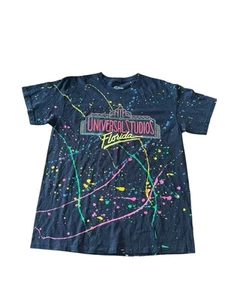 Camiseta Universal Studios Florida Grande Pintura Neón Salpicaduras Retro Negra - Imagen 1 de 5