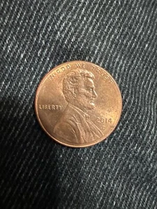 2014 D Penny Strike Through Error. Orange brownish color, not rusty, cleanish. - Picture 1 of 2