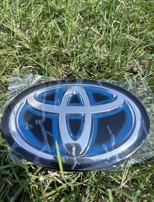🔥90975-C2022 Toyota Camry Hybrid 2021-2024 parrilla delantera radar emblema compatible Foto 1 de 4